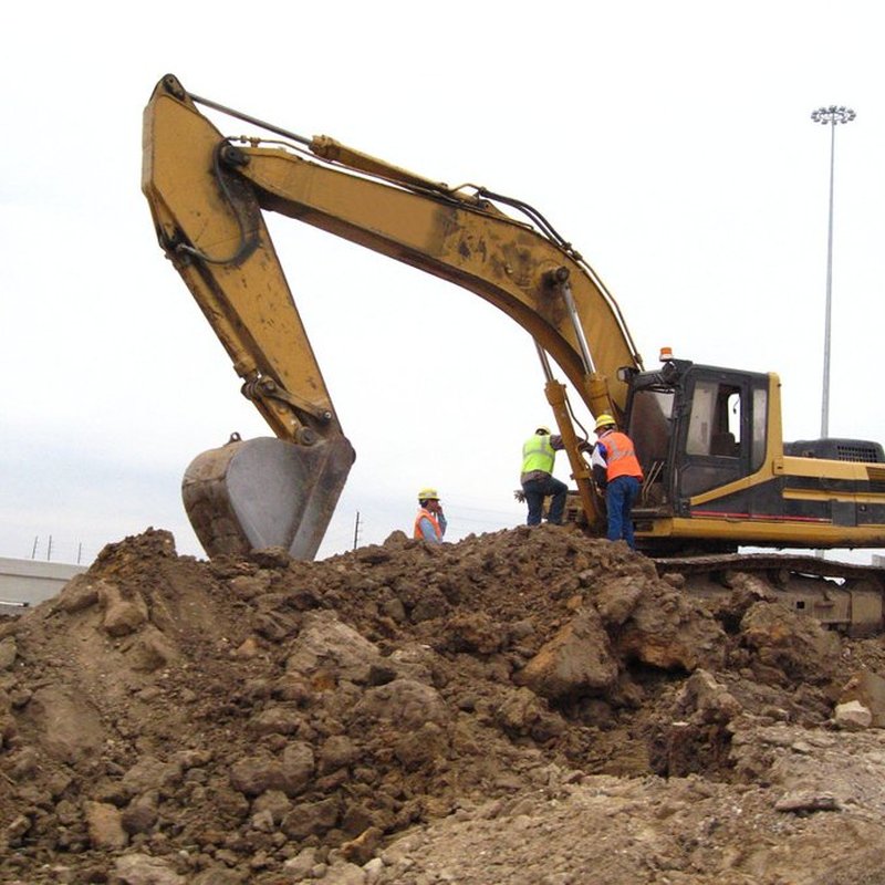 Tracked excavator digging on a job site