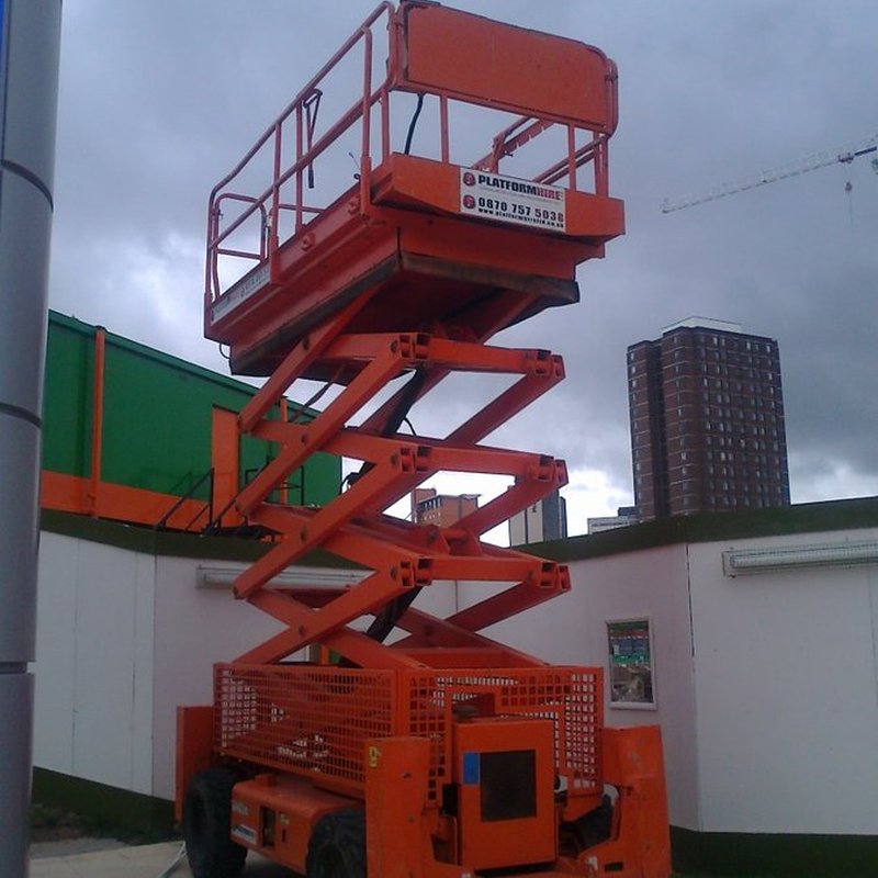 Red slab scissor lift with the platform raised