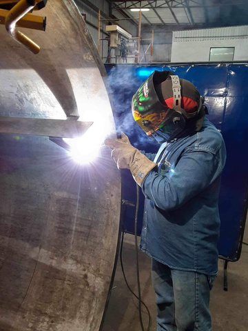 Welder running a bead on a large fabricated steel vessel