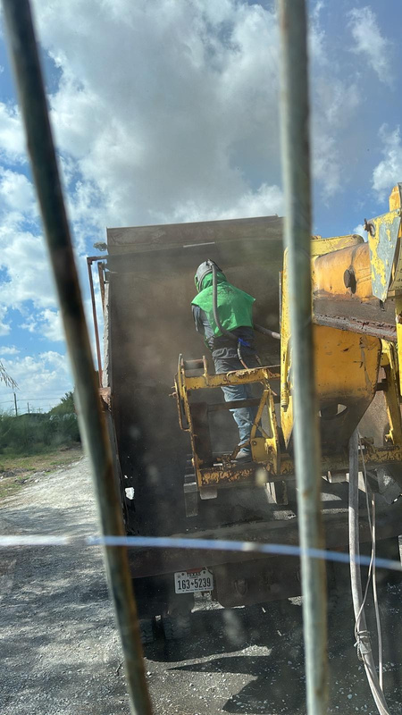 Operator blasting inside a dump truck bed