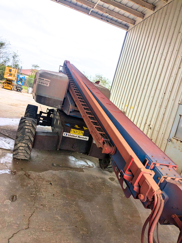 Rusted boom lift before restoration