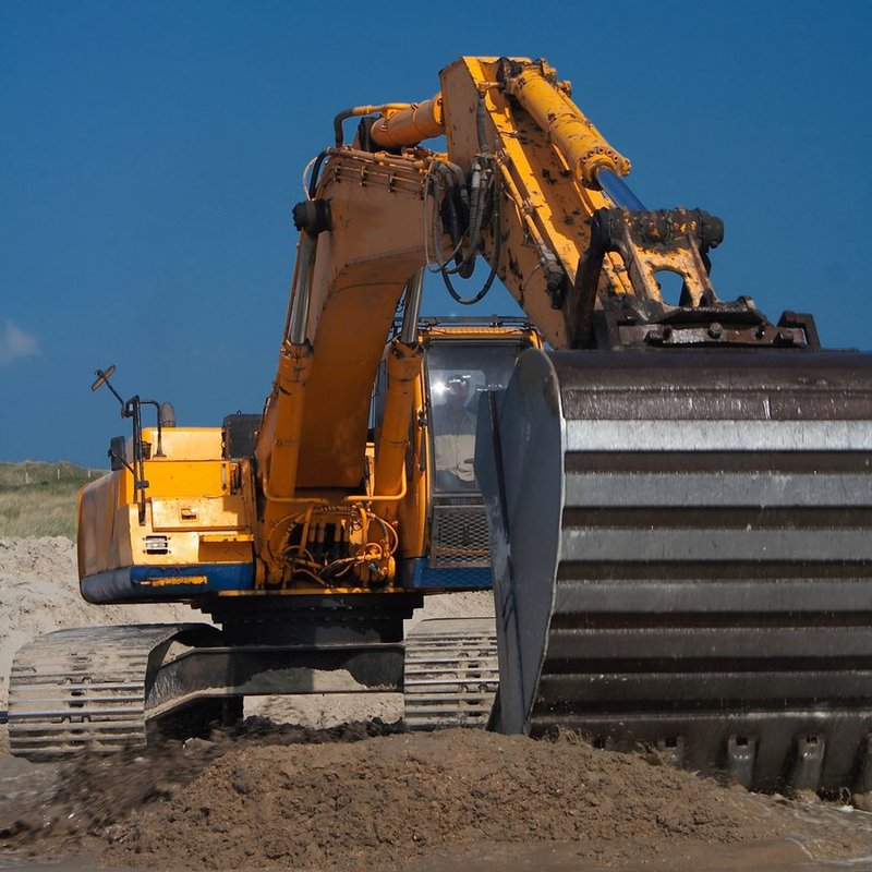 Large earthmoving excavator working a dirt pile